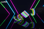 Glow bracelets in various colors on a hand against a black background