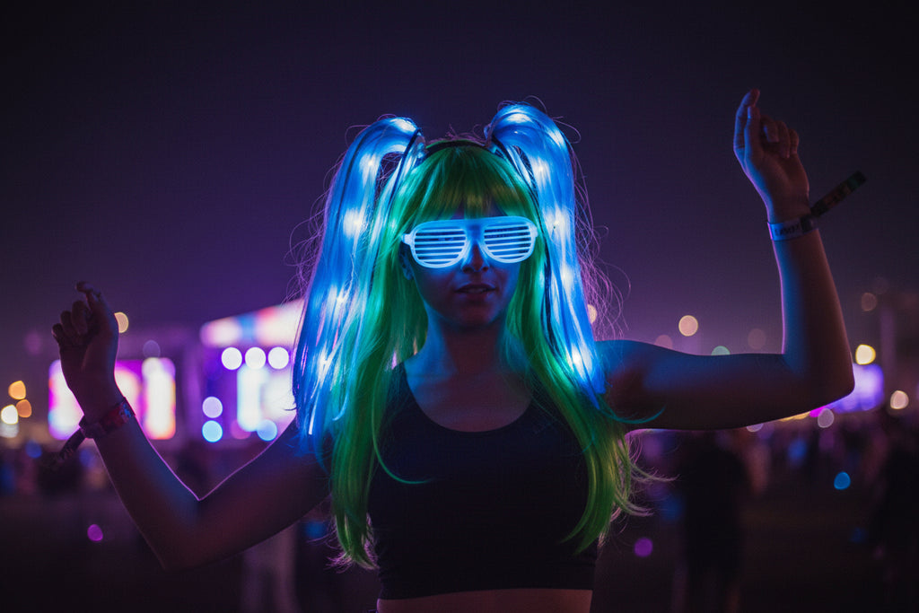 Mannequin head with green and blue LED wig and sunglasses on a black background