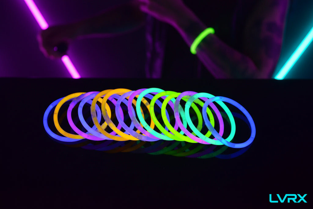 Neon glow bracelets in various colors on a black background