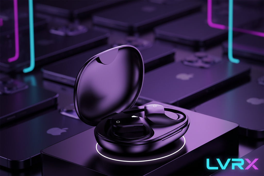 Black wireless earbuds in an open case on a blurred background of electronic devices.