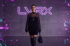 Black dress with sheer sleeves worn by a model against a neutral background