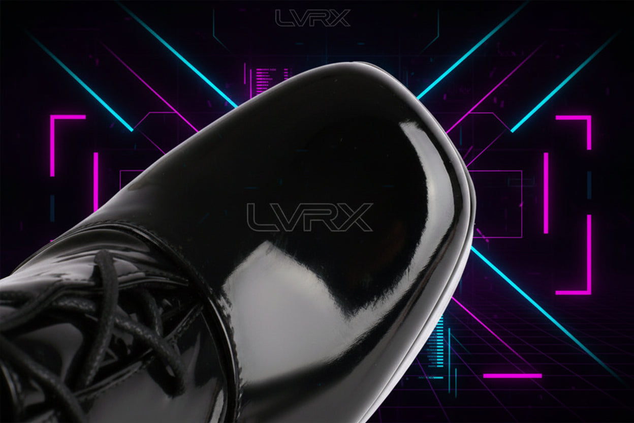 Close-up of a black patent leather shoe on a white background