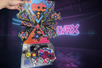 Colorful EDC (Electronic Dance Music) branded box with accessories on a red surface