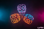 Three neon LED masks in black, orange, and blue on a dark background.
