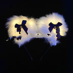 White furry headband with blue bows on a black background