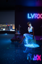 Model wearing LVRX fiber optic tube top and star glow skirt in a luxury Las Vegas VIP nightclub with neon lighting