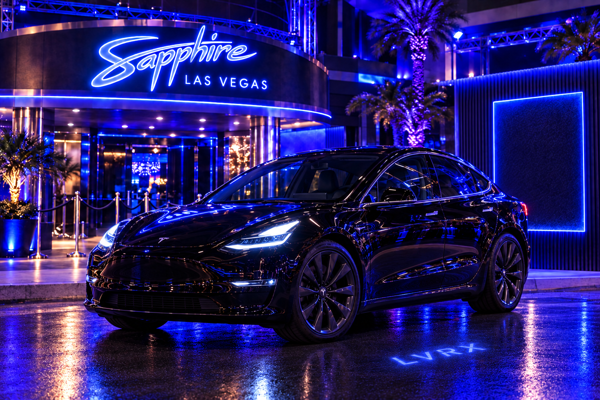 Black Tesla Model 3 outside Sapphire Las Vegas at night with a small LVRX hologram on the pavement.