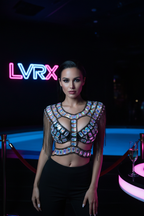 Model wearing LVRX gem bead chain crop top in a luxury Las Vegas VIP nightclub with neon lighting